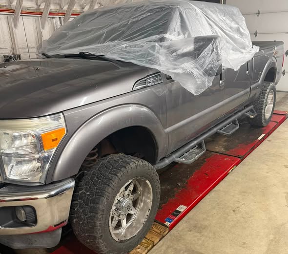 Heavy duty pickup prepped and covered in the shop bay
