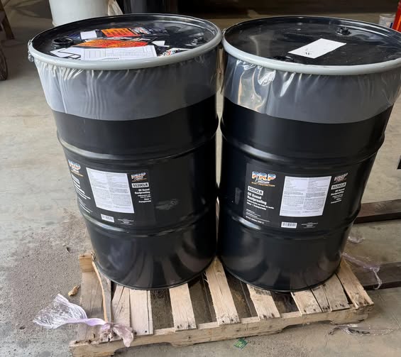 Drums of Platinum Rust Protection undercoating product in the shop