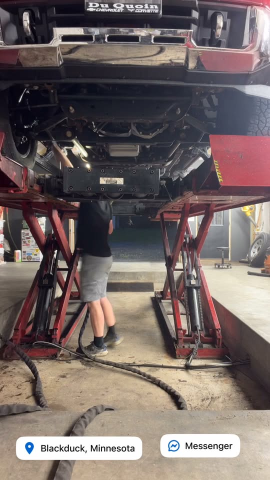 Truck raised on the shop lift being undercoated at Northern Rustproofing